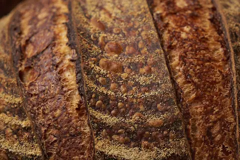 Closeup of two loaves of rustic sourdough bread — illustrative photo