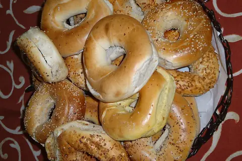 (A bagel also spelled beigel, is a bread product originating in the Jewish communities of Poland) — illustrative photo