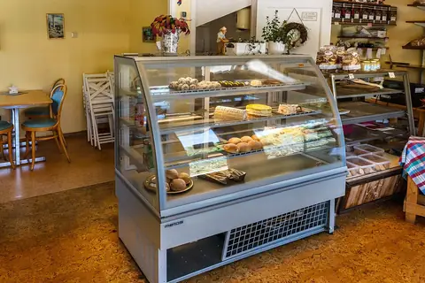 Cake display cases with cakes and pastries in Brastads Bageri 2 — illustrative photo